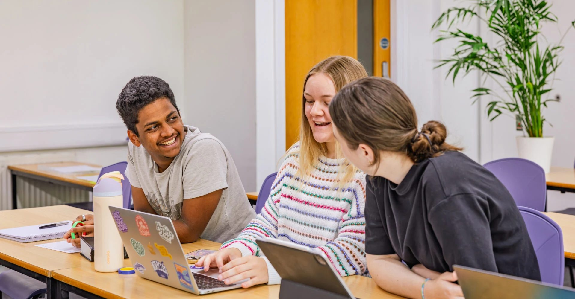 Students talking in a classroom at Nazarene Theological College